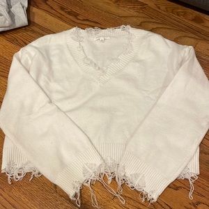 White sweater. distressed V neck
